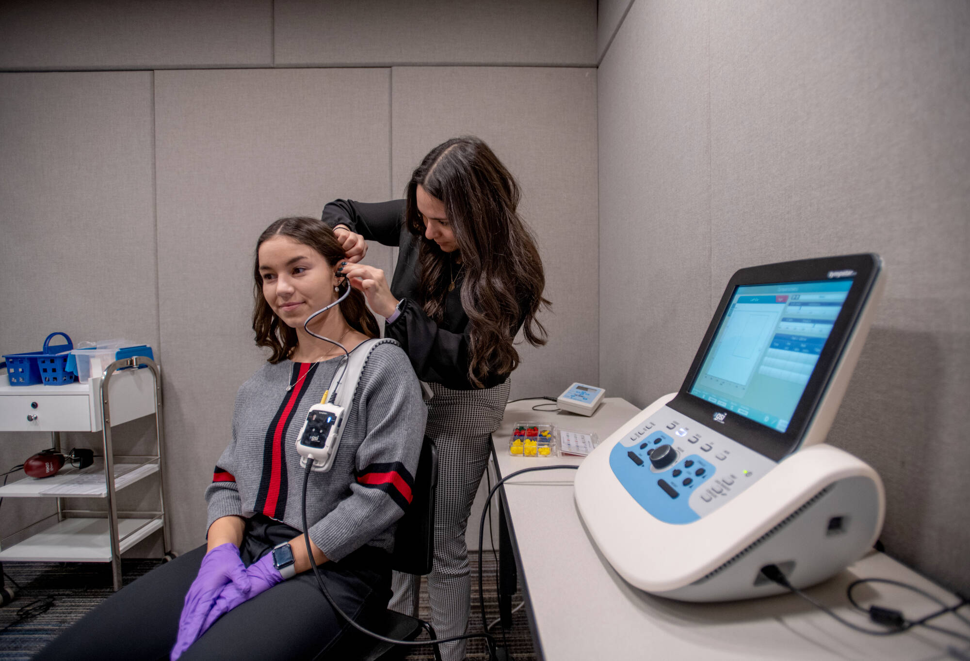 A student adhering testing equipment to another student